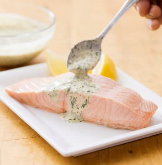 Poached salmon with dill and sour cream sauce