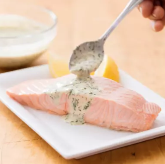 Poached salmon with dill and sour cream sauce