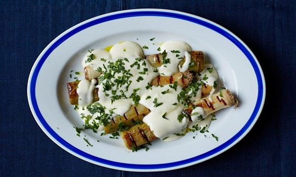 Poached then grilled leeks with cheddar cheese and cider sauce