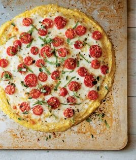Polenta pizza with tomatoes and fresh herbs