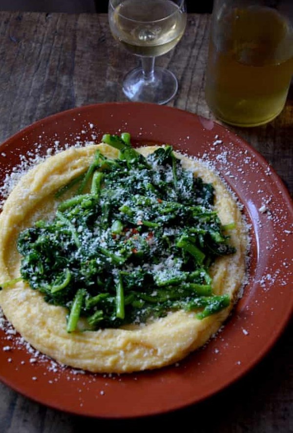 Polenta with butter, cheese and greens