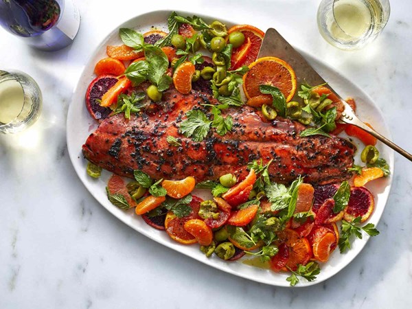 Pomegranate-glazed salmon with oranges, olives, and herbs
