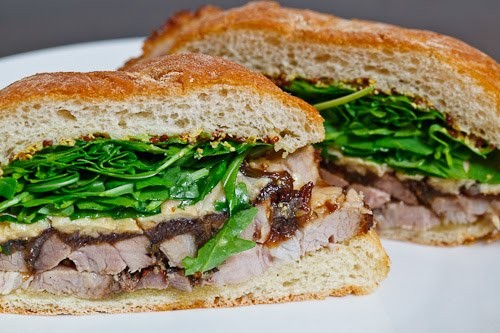 Porchetta sandwich with balsamic caramelized onions, Asiago cheese and arugula