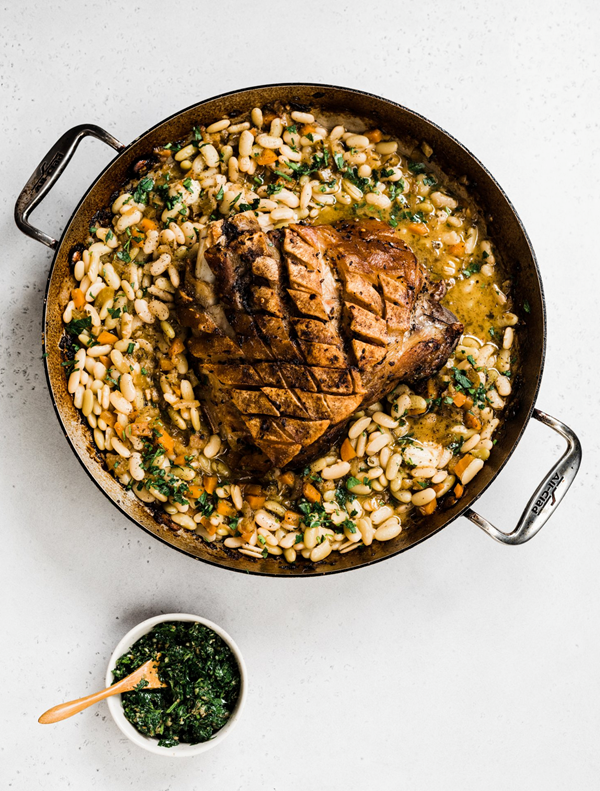 Porchetta-style bone-in pork picnic shoulder with white beans and salsa verde