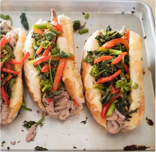 Pork and broccoli rabe cheesesteak sandwiches