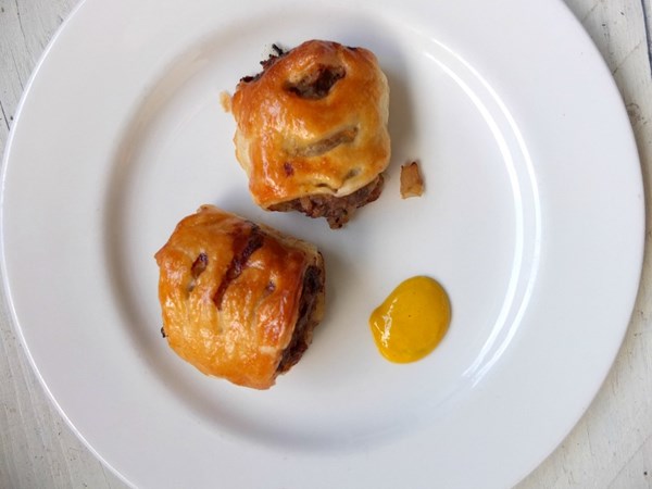 Pork and venison sausage rolls with sherry onions