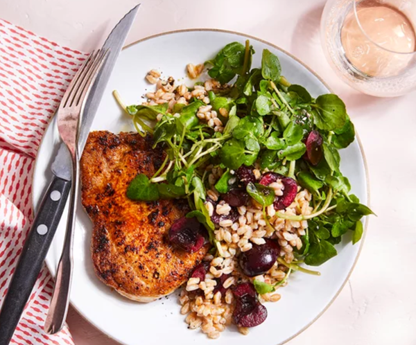 Pork chops with cherry, watercress & farro salad