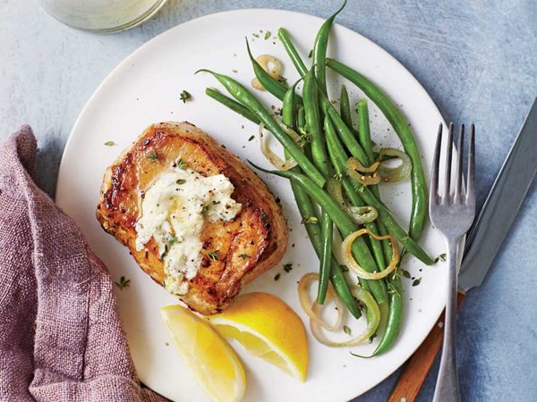 Pork chops with herbed goat cheese butter and green beans