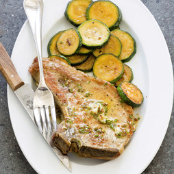 Pork chops with sautéed zucchini and mustard butter