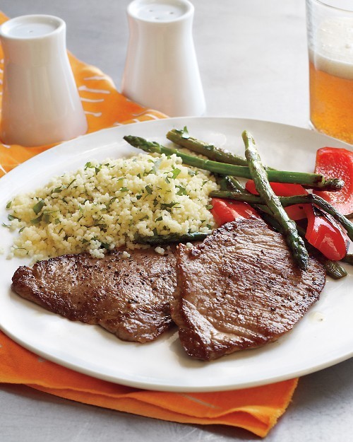 Pork cutlets with couscous and sautéed peppers and asparagus