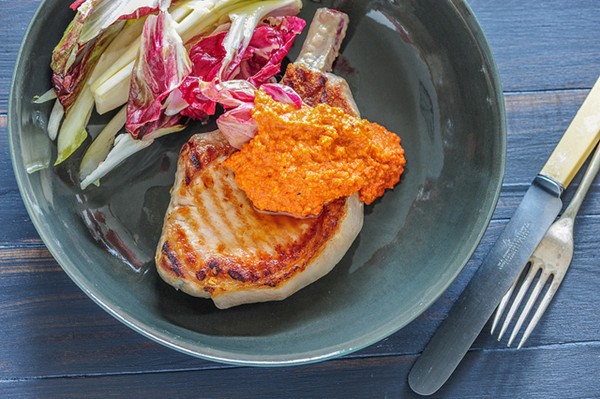 Pork cutlets with Romesco & bitter leaves
