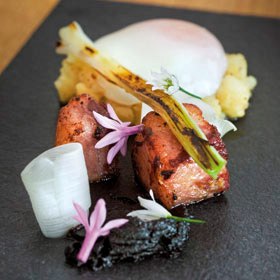 Pork jowls with potatoes, alliums, farm eggs & black garlic