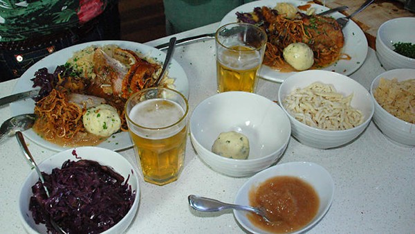 Pork knuckle with potato dumplings and braised red cabbage