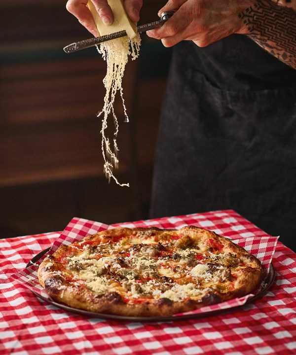 Pork sausage, caramelised leek, Danbo cheese & pickle relish pizza [Tom Kirton, aka Tommy Tomato]