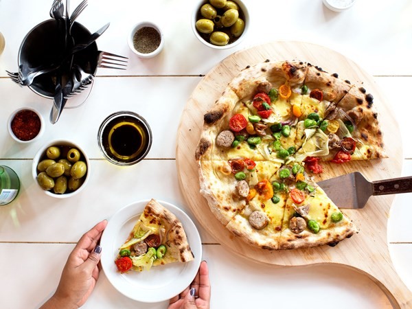 Pork sausage pizza with tricolour tomatoes, broad beans & fennel