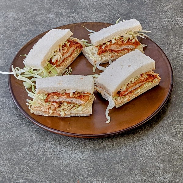 Pork schnitzel sandwich with spicy BBQ sauce (Tonkatsu sando)