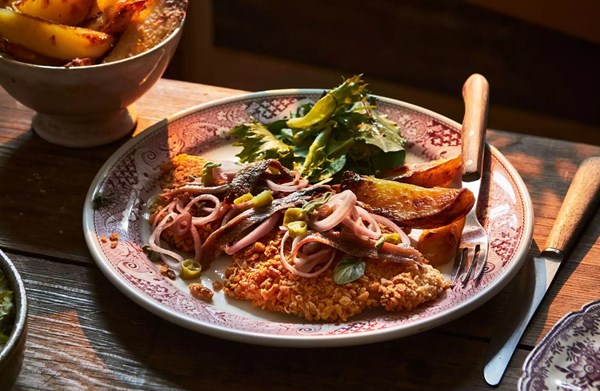 Pork schnitzels with pickled shallots, chillies, anchovies & potato wedges