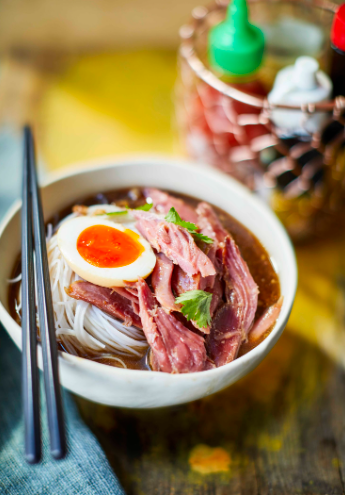 Pork shank braised in sweet soy with eggs and noodles