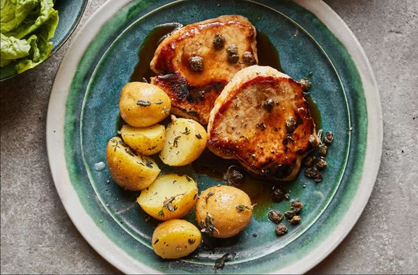 Pork steaks with buttery Jersey Royals, lemon & crispy capers