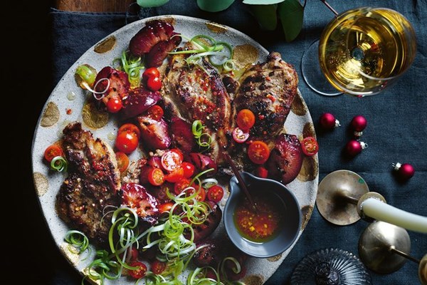 Pork steaks with grilled plums and tomatoes