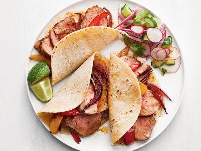 Pork tacos with onions and peppers