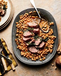 Pork tenderloin on white beans with gremolata