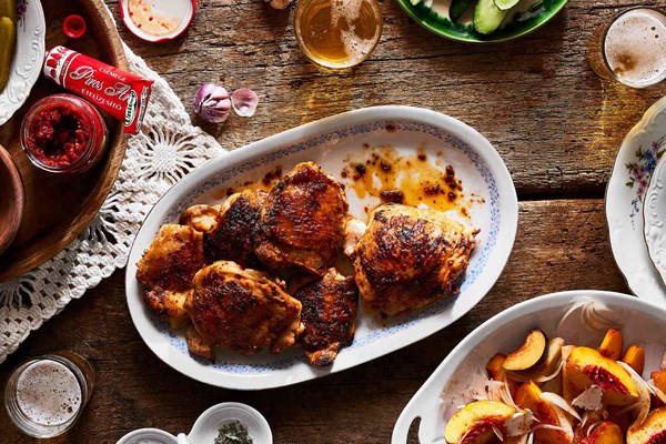 Pörkölt-style grilled chicken thighs with stone fruit, fennel, and paprika salad