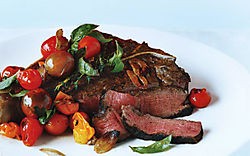 Porterhouse steak with pan-seared cherry tomatoes