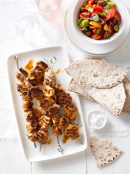 Portuguese chicken skewers with tomato salad and flatbread