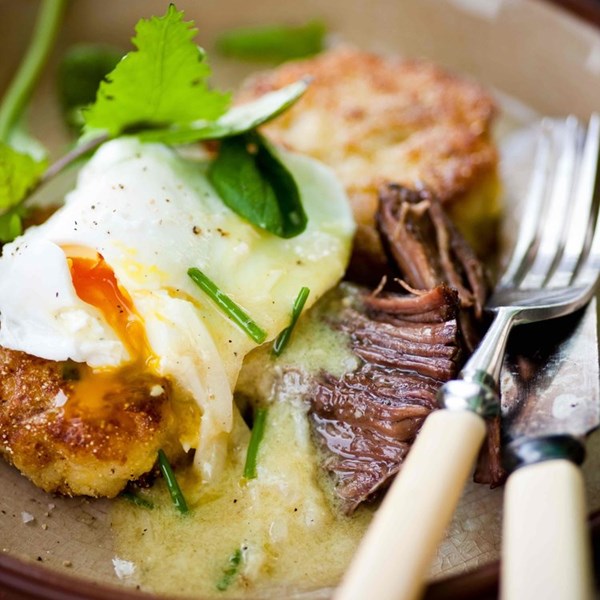 Pot roast potato cakes with poached eggs, fresh greens, and horseradish-mustard vinaigrette