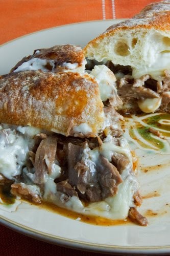 Pot roast sandwich smothered in gravy with melted Swiss cheese and horseradish mayonnaise