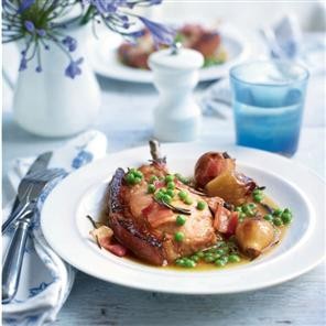 Pot-roasted pork chops in cider with shallots and peas
