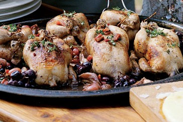 Pot-roasted poussin with Pinot, garlic and grapes