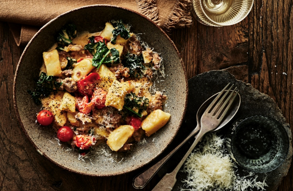 Potato gnocchi with pork sausage, cavolo nero and cherry tomato sauce