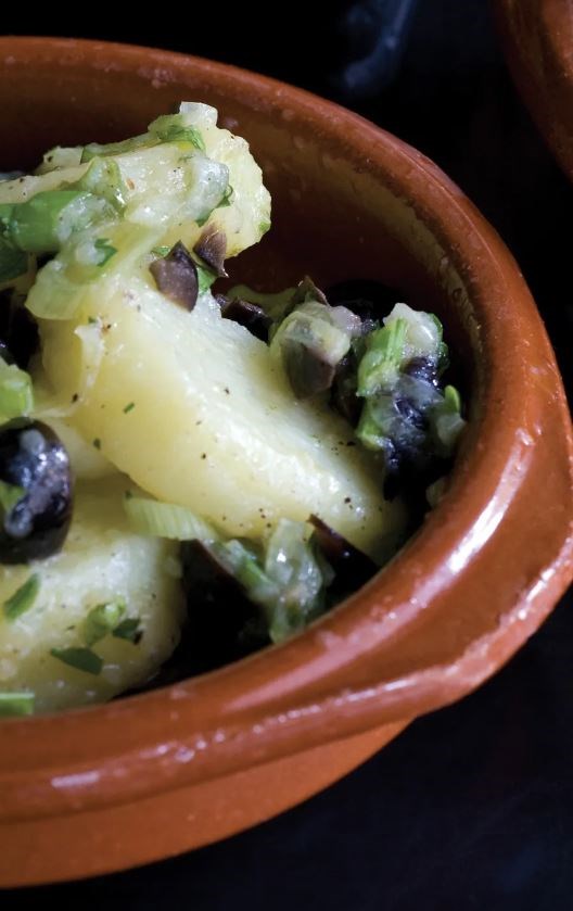 Potato salad with black olives, spring onions and olive oil