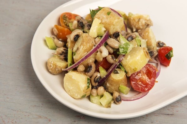 Potato salad with field peas, celery and cherry tomatoes