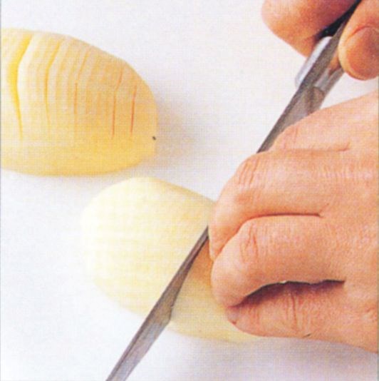 Preparing potatoes for roasting Hasselback style