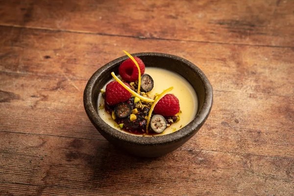 Preserved lemon panna cotta with pistachios and berry and mint compote
