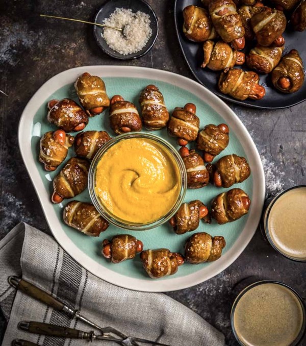Pretzel pigs in a blanket with cheddar-stout dip