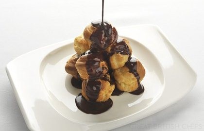 Profiteroles with passion fruit cream and chocolate sauce