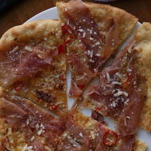 Prosciutto, chile, and onion pizza