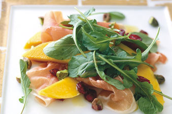 Prosciutto with persimmon, pomegranate, and arugula