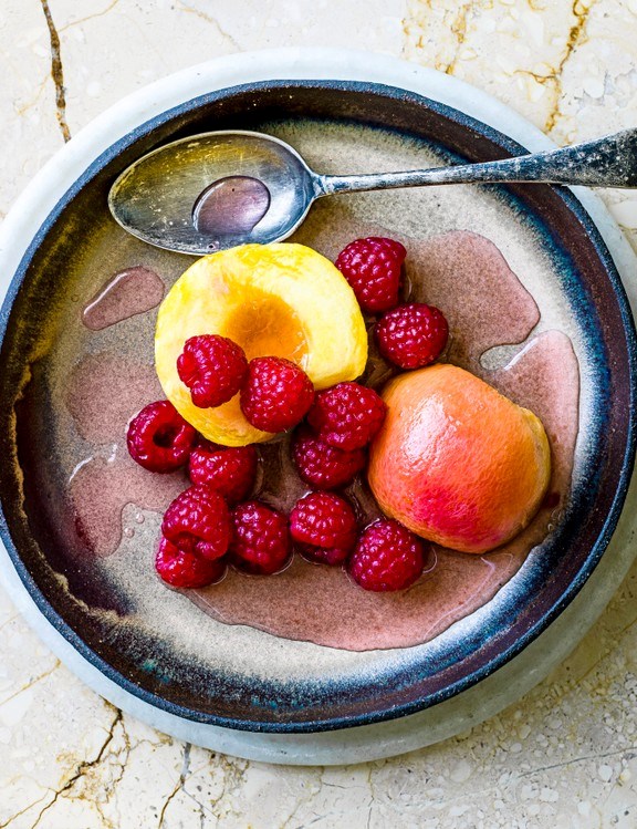Prosecco-poached peaches and raspberries