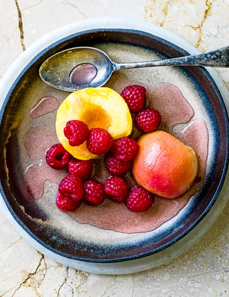 Prosecco poached peaches and raspberries