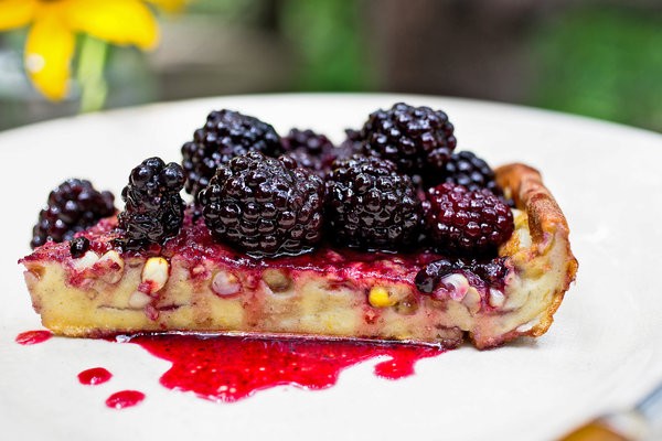 Puffy corn pancake with blackberry sauce