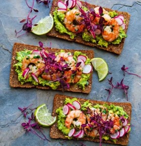 Pumpernickel with tiger prawns, garlic butter, avocado mash and radish