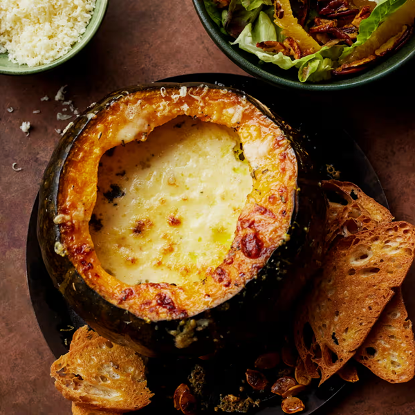 Pumpkin baked with cream, garlic, Gruyere and ciabatta croutes, with a salad of bitter leaves, pecans and orange