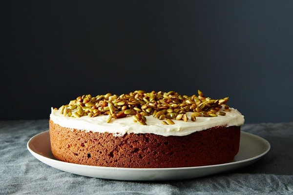Pumpkin cake with cream cheese icing and caramelized pumpkin seeds