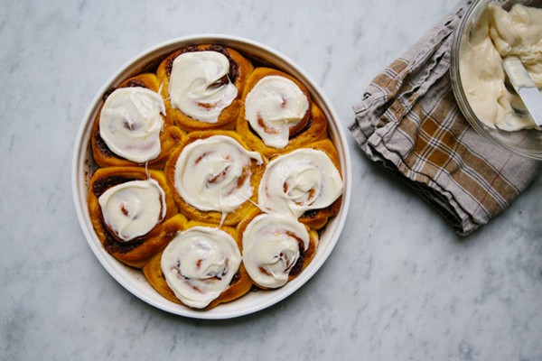 Pumpkin cinnamon rolls with orange cream cheese icing