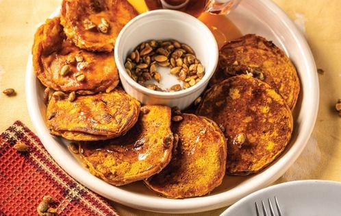 Pumpkin-cornmeal-cranberry pancakes with candied pecans